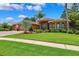 Stunning home featuring mature landscaping, elegant architectural details, and a well-manicured lawn at 5121 Delacroix Dr, Brooksville, FL 34604