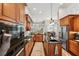 Gourmet kitchen with wood cabinetry, stainless steel appliances, and a spacious center island at 5121 Delacroix Dr, Brooksville, FL 34604