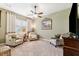 Spacious living room featuring carpet floors, comfortable chairs and a painting on the wall at 5121 Delacroix Dr, Brooksville, FL 34604