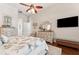 This main bedroom is well-lit with wood floors and a ceiling fan above the bed at 5121 Delacroix Dr, Brooksville, FL 34604