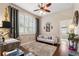 This home office includes a sofa, large window, and a ceiling fan above at 5121 Delacroix Dr, Brooksville, FL 34604