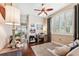 This home office includes a sofa, large window, and a ceiling fan above at 5121 Delacroix Dr, Brooksville, FL 34604
