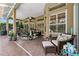 Inviting covered patio featuring brick flooring, ceiling fans, and comfortable seating area for relaxation at 5121 Delacroix Dr, Brooksville, FL 34604