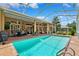 Backyard pool with covered lanai and outdoor seating, perfect for relaxing and entertaining at 5121 Delacroix Dr, Brooksville, FL 34604