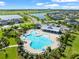 Aerial view of a community pool with playground and beautiful landscaping at 6130 Colmar Pl, Apollo Beach, FL 33572