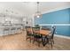 Dining room open to the kitchen featuring stylish decor and ample natural light at 6130 Colmar Pl, Apollo Beach, FL 33572