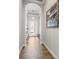 Stylish foyer with archway, beautiful wood-look tile, and decorative chandelier at 6130 Colmar Pl, Apollo Beach, FL 33572