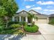 Charming single-story home with manicured landscaping, a well-kept lawn, and a welcoming driveway at 6130 Colmar Pl, Apollo Beach, FL 33572