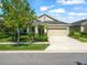 Charming single-story home with manicured landscaping, a well-kept lawn, and a welcoming driveway at 6130 Colmar Pl, Apollo Beach, FL 33572