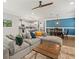 Comfortable living area with gray sectional sofa, dining area, and modern lighting at 6130 Colmar Pl, Apollo Beach, FL 33572