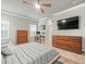 Comfortable main bedroom with a desk, dual dressers, and a large ceiling fan at 6130 Colmar Pl, Apollo Beach, FL 33572