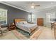 Well-lit main bedroom with hardwood floors, neutral walls, and a decorative rug at 6130 Colmar Pl, Apollo Beach, FL 33572
