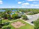 Aerial view of a colorful community playground with swings, slides, and lake views at 6130 Colmar Pl, Apollo Beach, FL 33572