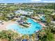 Aerial view of a resort-style community pool featuring lounge chairs and a smaller splash pool for children at 6130 Colmar Pl, Apollo Beach, FL 33572