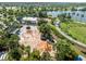 Aerial shot of a community splash pad and playground surrounded by lush landscaping and a lake at 6130 Colmar Pl, Apollo Beach, FL 33572