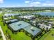 Aerial view of well-maintained tennis courts and other community amenities, perfect for an active lifestyle at 6130 Colmar Pl, Apollo Beach, FL 33572