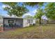 Spacious backyard with a screened patio and playground, ideal for outdoor living and play at 6144 Glenwood Dr, New Port Richey, FL 34653