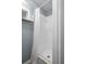 Bathroom features a white tiled shower and a modern white shower curtain at 6144 Glenwood Dr, New Port Richey, FL 34653