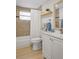 Bathroom featuring a shower/tub, light-colored tile, vanity and decorative mirror at 6144 Glenwood Dr, New Port Richey, FL 34653