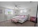 Bedroom with windows allowing natural light, a ceiling fan and decorative furnishings at 6144 Glenwood Dr, New Port Richey, FL 34653