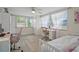 Bedroom featuring a day bed, a desk, a chair, and large windows allowing natural light at 6144 Glenwood Dr, New Port Richey, FL 34653