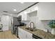 Bright kitchen features stainless steel appliances, granite countertops, and white cabinets at 6144 Glenwood Dr, New Port Richey, FL 34653