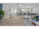 Open-concept kitchen with a breakfast bar, stainless steel appliances, and hardwood floors at 6144 Glenwood Dr, New Port Richey, FL 34653