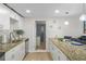 Well-lit kitchen with modern appliances, granite countertops, and an open view to the living area at 6144 Glenwood Dr, New Port Richey, FL 34653