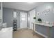 Bright laundry room with sink, countertop, and storage baskets, perfect for efficient home management at 6144 Glenwood Dr, New Port Richey, FL 34653