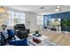 Cozy living room featuring a stylish blue accent wall, a fireplace, and modern decor at 6144 Glenwood Dr, New Port Richey, FL 34653