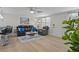Bright living room with hardwood floors, a black leather sofa set, and tasteful decor at 6144 Glenwood Dr, New Port Richey, FL 34653