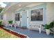 Inviting front porch with comfortable seating and light blue trim, creating a cozy and welcoming entrance at 6144 Glenwood Dr, New Port Richey, FL 34653