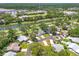 Beautiful aerial view showcasing a community near a pond, surrounded by mature trees and landscaping at 6282 Darien Way, Spring Hill, FL 34606