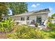 A charming backyard with lush landscaping and comfortable seating on the patio, ideal for enjoying the outdoors at 6282 Darien Way, Spring Hill, FL 34606