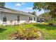 A lovely backyard featuring well-maintained landscaping, green grass, and a relaxing patio area with seating at 6282 Darien Way, Spring Hill, FL 34606
