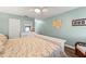 Bedroom with a wicker chair, light blue walls, and a ceiling fan at 6282 Darien Way, Spring Hill, FL 34606