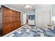 Bedroom featuring light aqua walls, wood look floors, and a built in armoire at 6282 Darien Way, Spring Hill, FL 34606