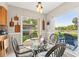 Bright breakfast nook featuring a glass-topped table, wicker chairs, and serene views of the outdoors at 6282 Darien Way, Spring Hill, FL 34606