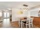 Open-concept dining room with wood flooring, a decorative lighting fixture, and access to the living room at 6282 Darien Way, Spring Hill, FL 34606