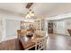 Spacious dining room featuring wood floors, a hanging light fixture, and access to the kitchen at 6282 Darien Way, Spring Hill, FL 34606