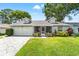Charming single-story home with a well-maintained lawn, screened porch, and two-car garage at 6282 Darien Way, Spring Hill, FL 34606