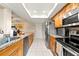 Spacious kitchen with stainless steel appliances, wood cabinets, and lots of counter space at 6282 Darien Way, Spring Hill, FL 34606