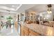Large kitchen with stainless steel appliances, wood cabinets, granite counters and view to breakfast nook at 6282 Darien Way, Spring Hill, FL 34606