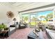 Screened lanai featuring comfortable wicker seating and views of the neighborhood at 6282 Darien Way, Spring Hill, FL 34606