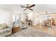 Spacious living room with wood-look floors flowing into an adjacent kitchen and dining area at 6282 Darien Way, Spring Hill, FL 34606