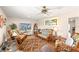 Cozy living room featuring comfortable wicker seating, wood-look floors and stylish decor at 6282 Darien Way, Spring Hill, FL 34606