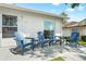 A cozy outdoor patio with seating, perfect for relaxing or entertaining with an easy access door to the home at 6282 Darien Way, Spring Hill, FL 34606