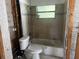 Bathroom featuring a shower and toilet, ready for renovation at 6826 Driftwood Dr, Hudson, FL 34667