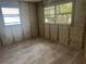 This bedroom features new vinyl floors, block wall construction, and a large window letting in natural light at 6826 Driftwood Dr, Hudson, FL 34667