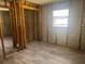 This bedroom features new vinyl floors, block wall construction, and a large window letting in natural light at 6826 Driftwood Dr, Hudson, FL 34667